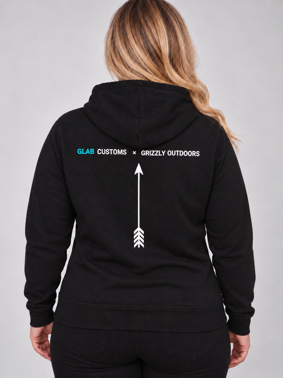 Bec modelling the back of the black Grizzly Outdoors hoodie