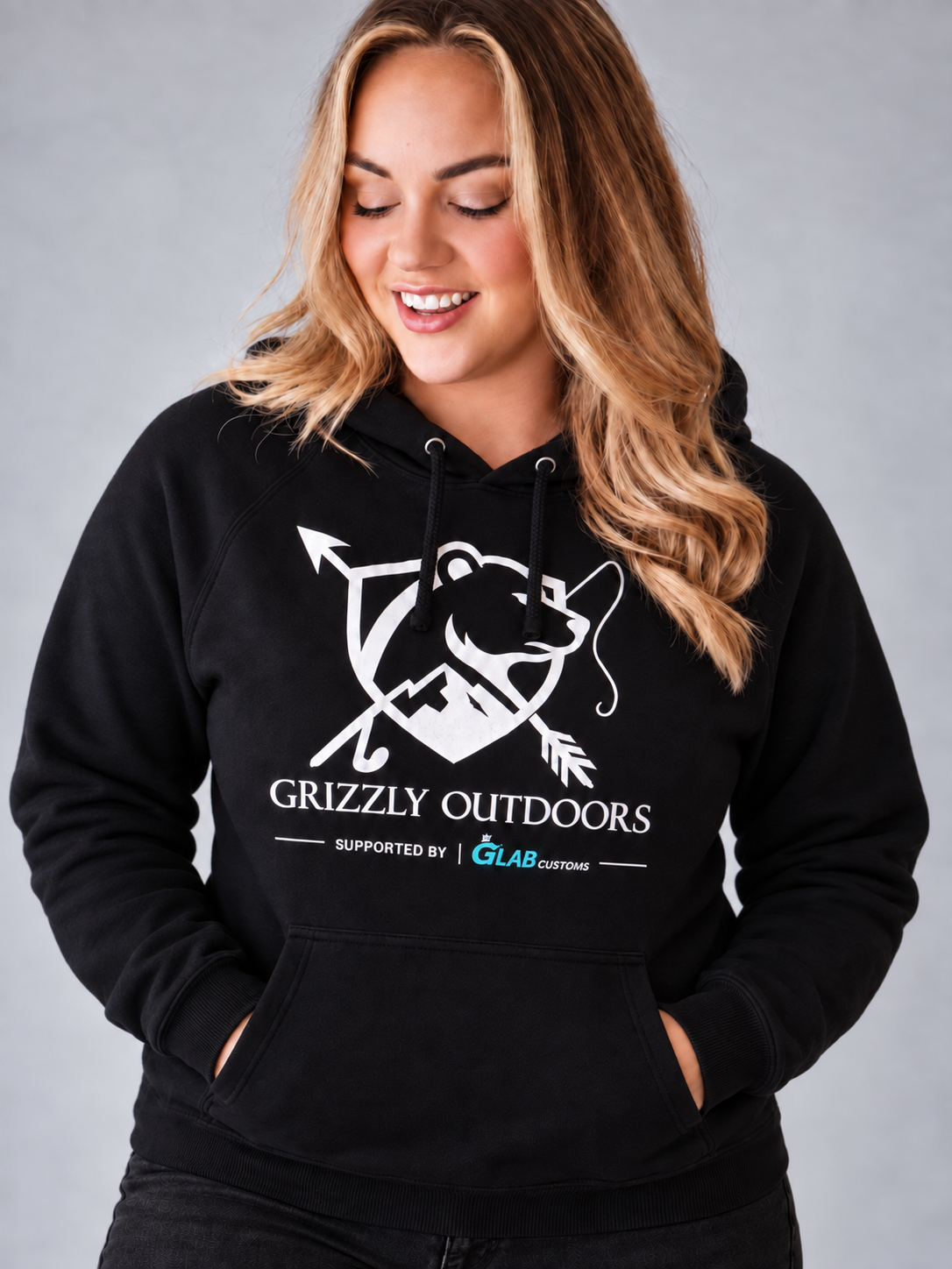 Bec modelling the front of the black Grizzly Outdoors hoodie